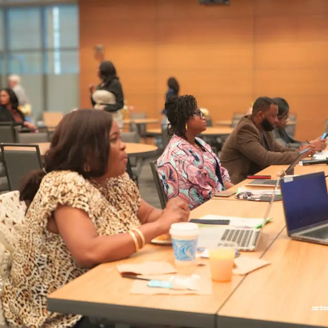 Attendees seated at a conference table